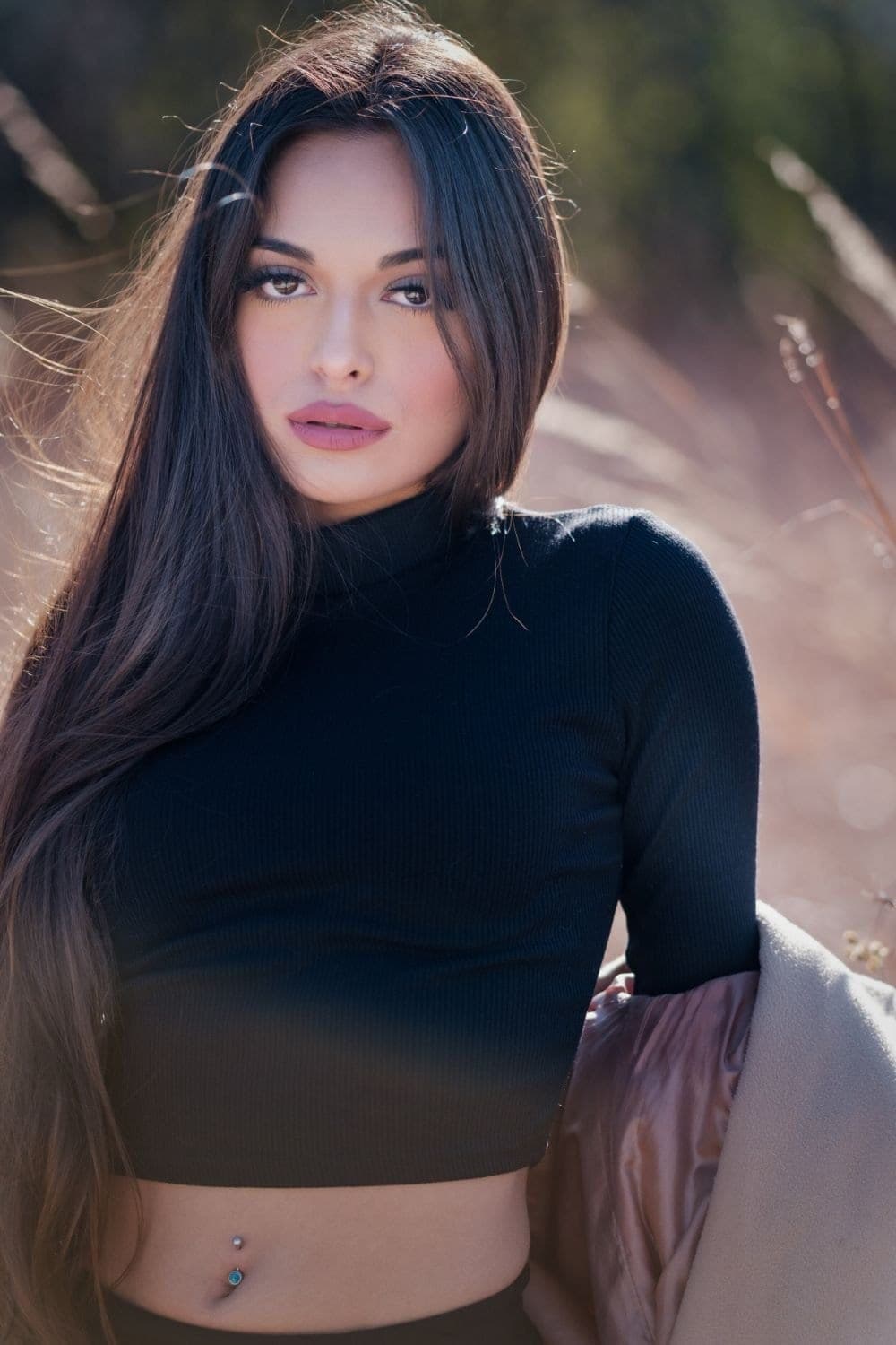 Portrait commission by Henry David: dark turtleneck and long dark hair in quiet available light