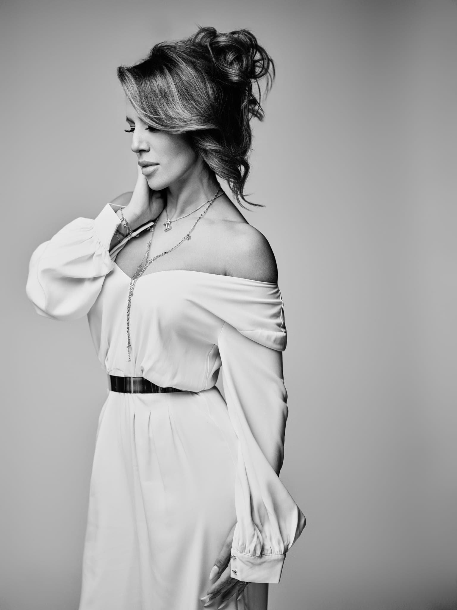 Fine art black and white portrait in soft studio light, elegant updo and white dress, painterly mood, by Henry David