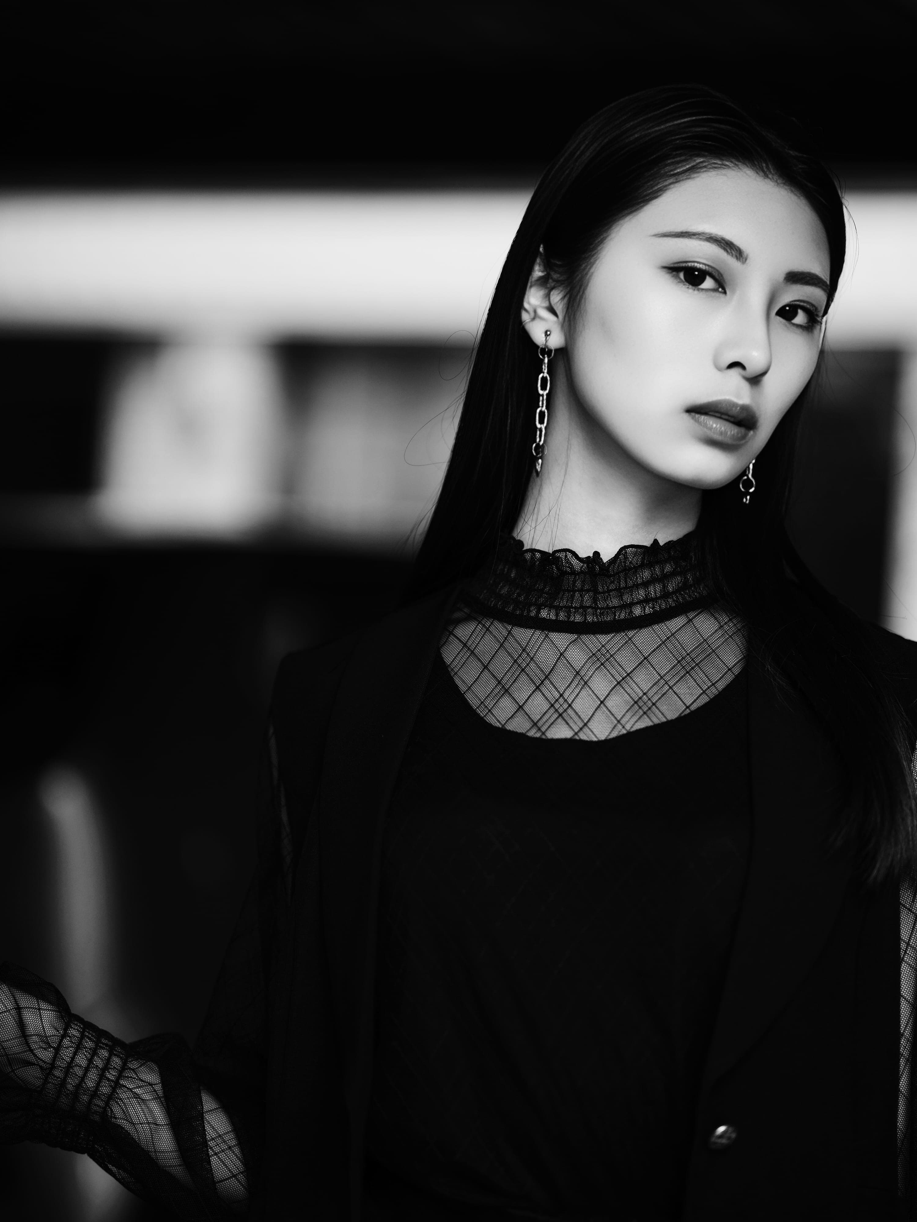Anna close in a sheer lace high collar and drop earrings, low light, black and white